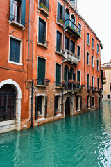 Fototapeta na wymiar Traditional Building on Canal in Venice, Italy