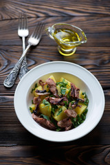 Glass plate with octopus salad, selective focus, studio shot