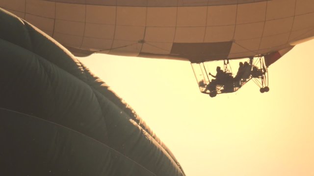 Crew of zeppelin flying at dawn on a balloon festival