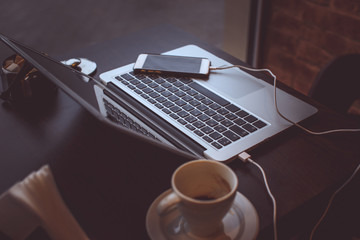 A laptop's keyboard and a cup of coffee.