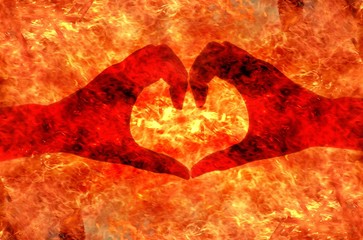 heart shape by hand on fire background