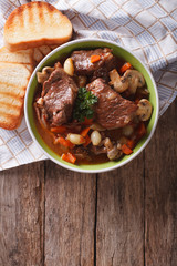 Homemade Beef Bourguignon in a bowl on the table. vertical top view

