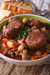 Beef Bourguignon with mushrooms close up in a bowl. Vertical
