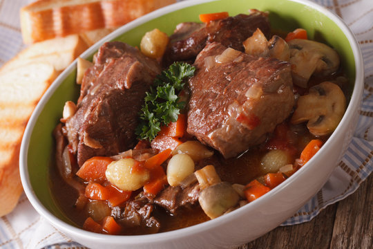 Beef Bourguignon with vegetables close-up in a bowl. horizontal
