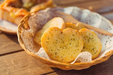 Garlic bread served in baskets on table