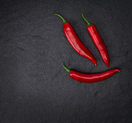 chili pepper on black stone background