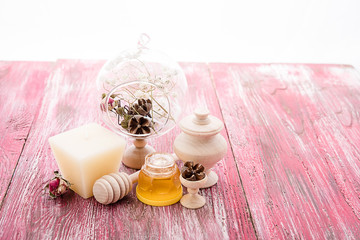 Obraz na płótnie Canvas spa treatment - star anise, honey, salt, arranged with soap bar, pebbles and towels on wood