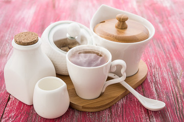 Tea cups with teapot on old wooden table