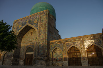 Fototapeta na wymiar Morning sun in wall of madrasas with traditional mosaic ornament . Samarkand, Uzbekistan