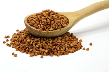 Buckwheat grains in wooden spoon