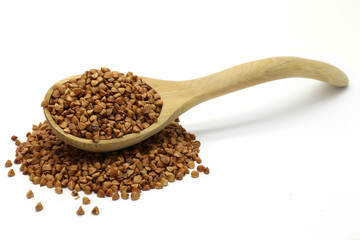 Buckwheat grains in wooden spoon
