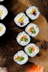 Closeup of fresh sushi on rustic wooden table