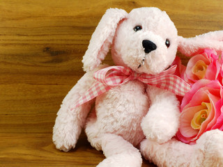 cute pink dog doll and artificial rose flower decoration