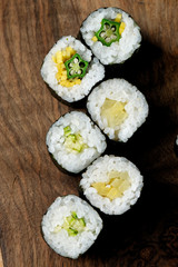 Closeup of fresh sushi on rustic wooden table