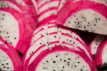 Dragon fruit sliced up and arranged  on  background