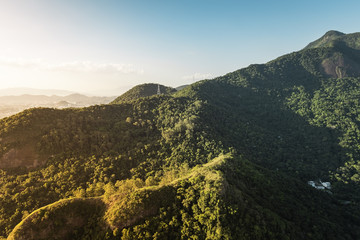 Green forest with mountains around the city aerial view, Brazil