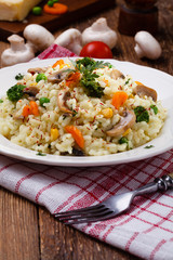 Classic Risotto with mushrooms and vegetables served on a white