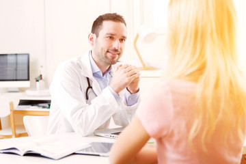 Young attractive doctor listening his patient