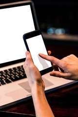 Woman texting and using laptop