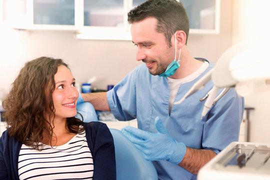 Young attractive woman being cured by a dentist