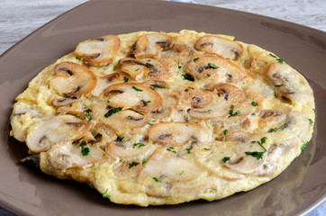 Delicious omelet with mushrooms and tomatoes