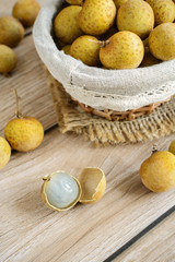 Longan (Dimocarpus longan) and peel on wooden table