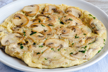 Delicious omelet with mushrooms and tomatoes