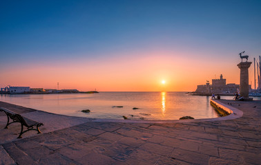 Colorful sunrise in Mandraki harbor Rhodes, Greece
