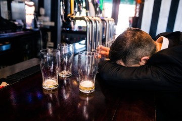 Drunk man with empty glasses