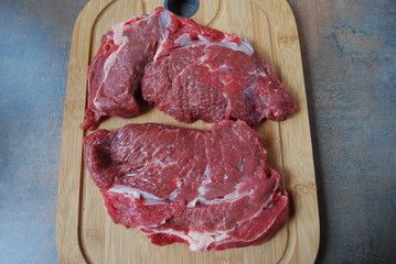 Fresh beef steak on a cutting board.