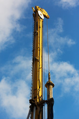 Fototapeta na wymiar piling machines and cranes with bright sky