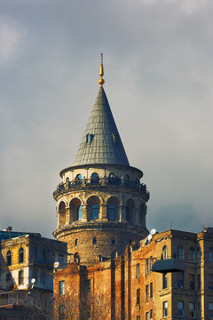 One of the symbols of Istanbul city, aesthetic and beautiful Galata Tower behind other unaesthetic buildings