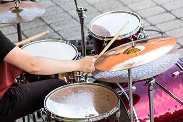 hand of drummer with sticks and drums