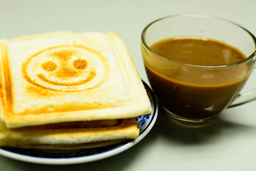 Coffee and toasts on glass table