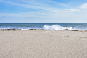 Beautiful beach on the Pacific ocean with waves splashing, near Leon, Nicaragua