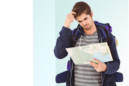 Composite image of man scratching head looking in map