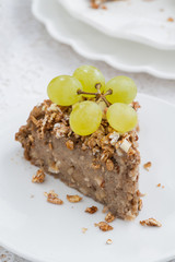 piece of nut pie with grapes, top view