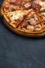 Pizza with cheese and sausage, vertical