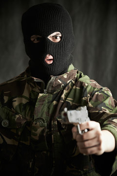 Portrait Of Terrorist With Gun Addressing Camera