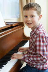 Portrait Of Young Boy Playing Piano At Home