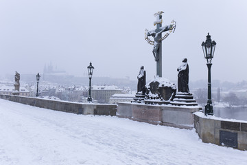 Snowy foggy Prague Lesser Town with gothic Castle from Charles Bridge, Czech Republic