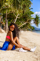 Beautiful teenage black girl in sunglasses, bra and skirt.