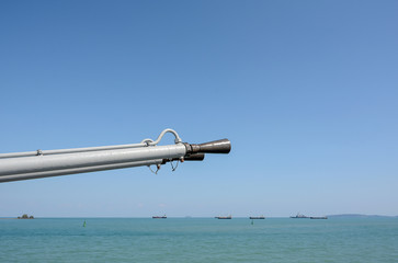 Army gun on the boat with sea and sky background,close up on gun