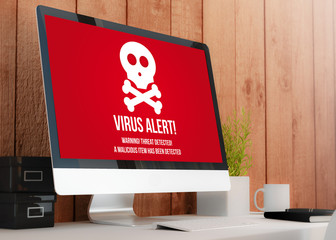 modern workspace with computer showing virus alert