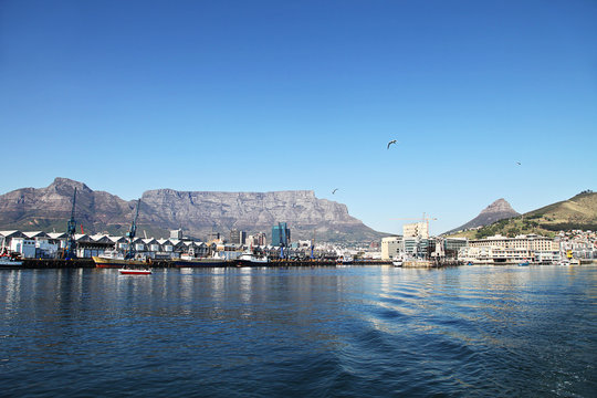 Cape Town, South Africa - Stadium and Waterfront and harbour with Table Mountain in the background.
