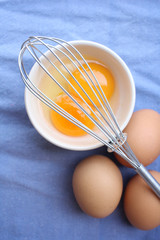 Fototapeta na wymiar Eggs in a bowl with whisk