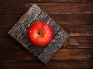 red apple on a wooden table