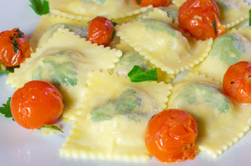 Fresh homemade ravioli pasta with tomato and parsley