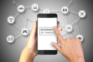 Hand holding smart phone with Internet of Things concept