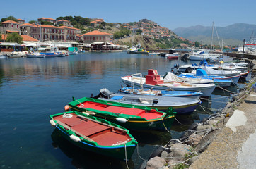 Fototapeta na wymiar Molyvos Harbor with boats and castle in background on the island of Lesvos Greece